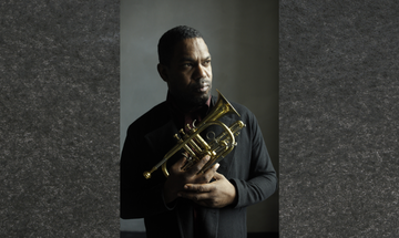 Trumpeter Byron Wallen holding a cornet.