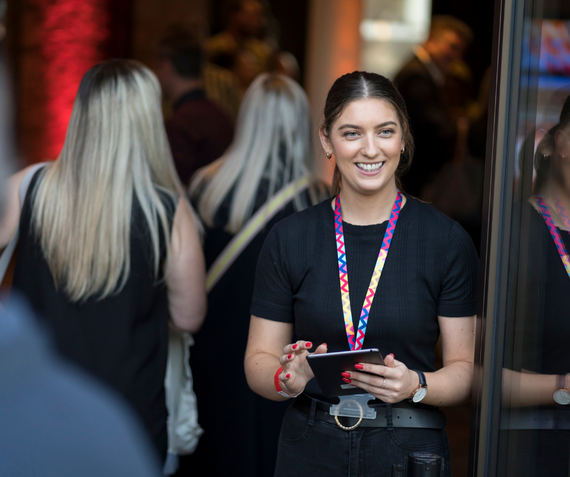 A volunteer at Woolwich Works who is welcoming guests at the entrance