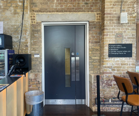 The door to the toilets from the Visitors' Book Cafe at Woolwich Works