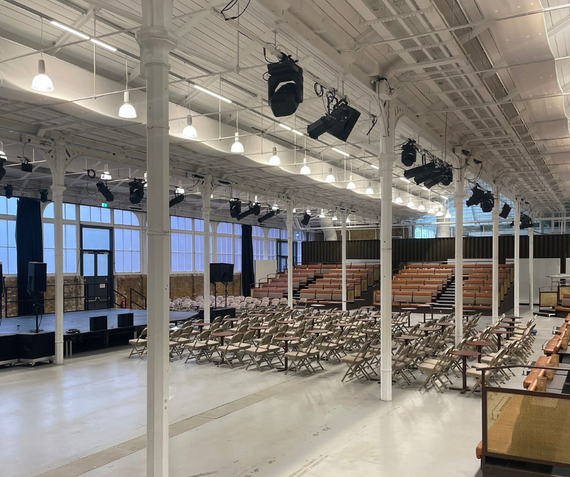 Inside the Fireworks Factory, the main space at Woolwich Works, with chairs set up in front of a stage