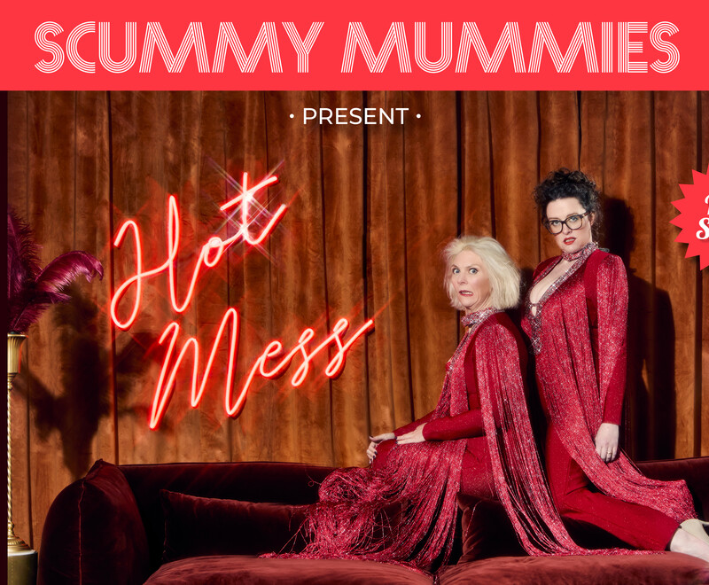 Scummy Mummies dressed in red dresses in front of a curtain